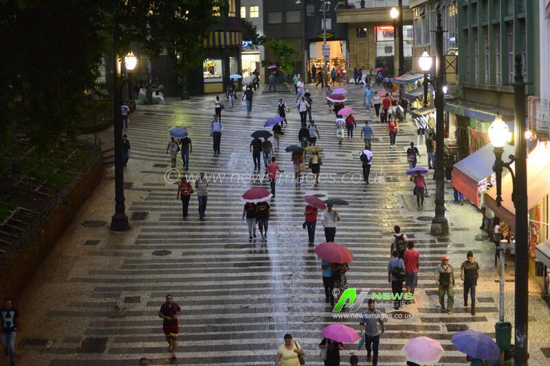 Pedestrians face rain in downtown Sao Paulo