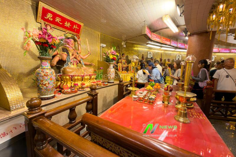 Believers praying to Tai Sui at the Yuen Yuen Institute in the Year of Horse