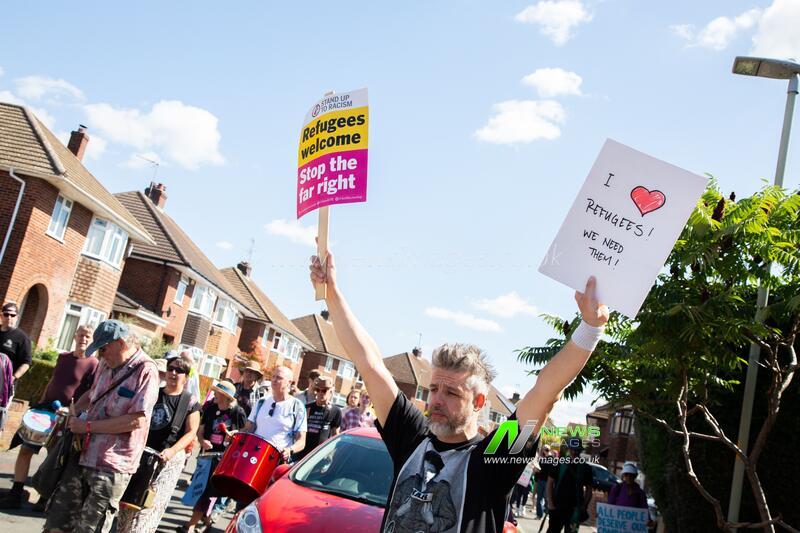 Activist holds pro-refugee sign during Gloucester protest