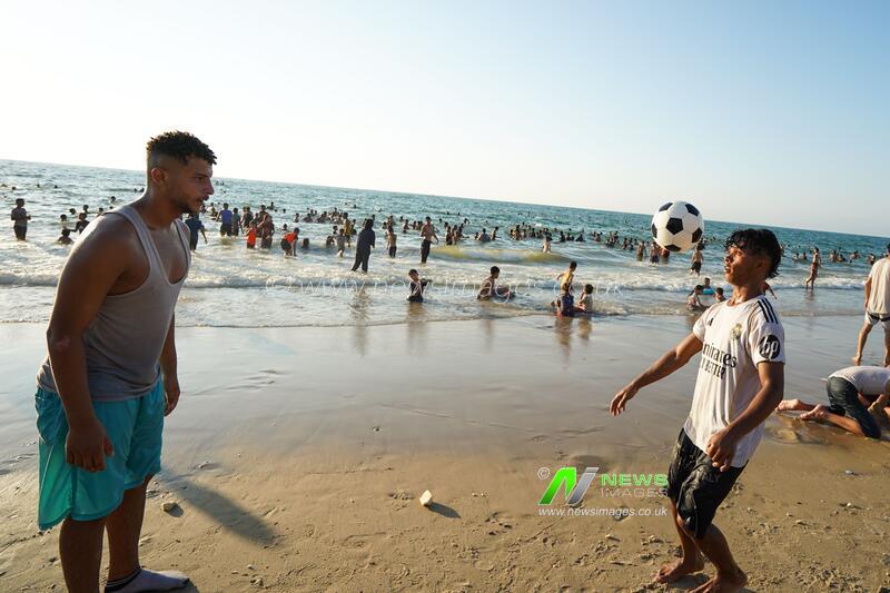 Palestinians seek relief from summer heat on Gaza beach