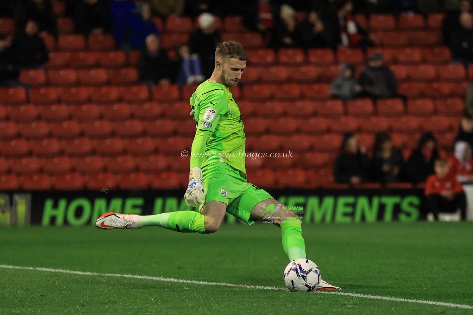 Bradley Collins #40 of Barnsley kicks the ball out