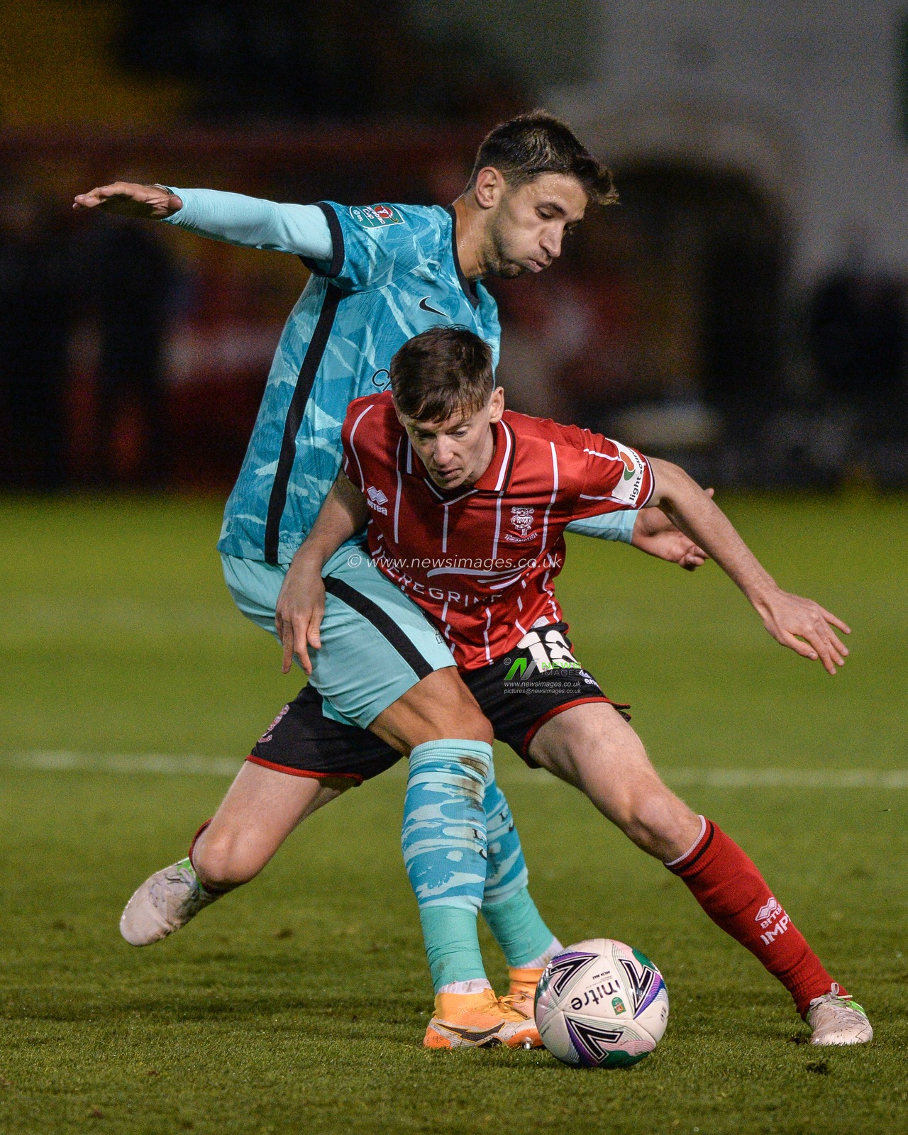 Marko GrujiÄ‡ (16) of Liverpool  and Joe Walsh (16) of Lincoln City clash