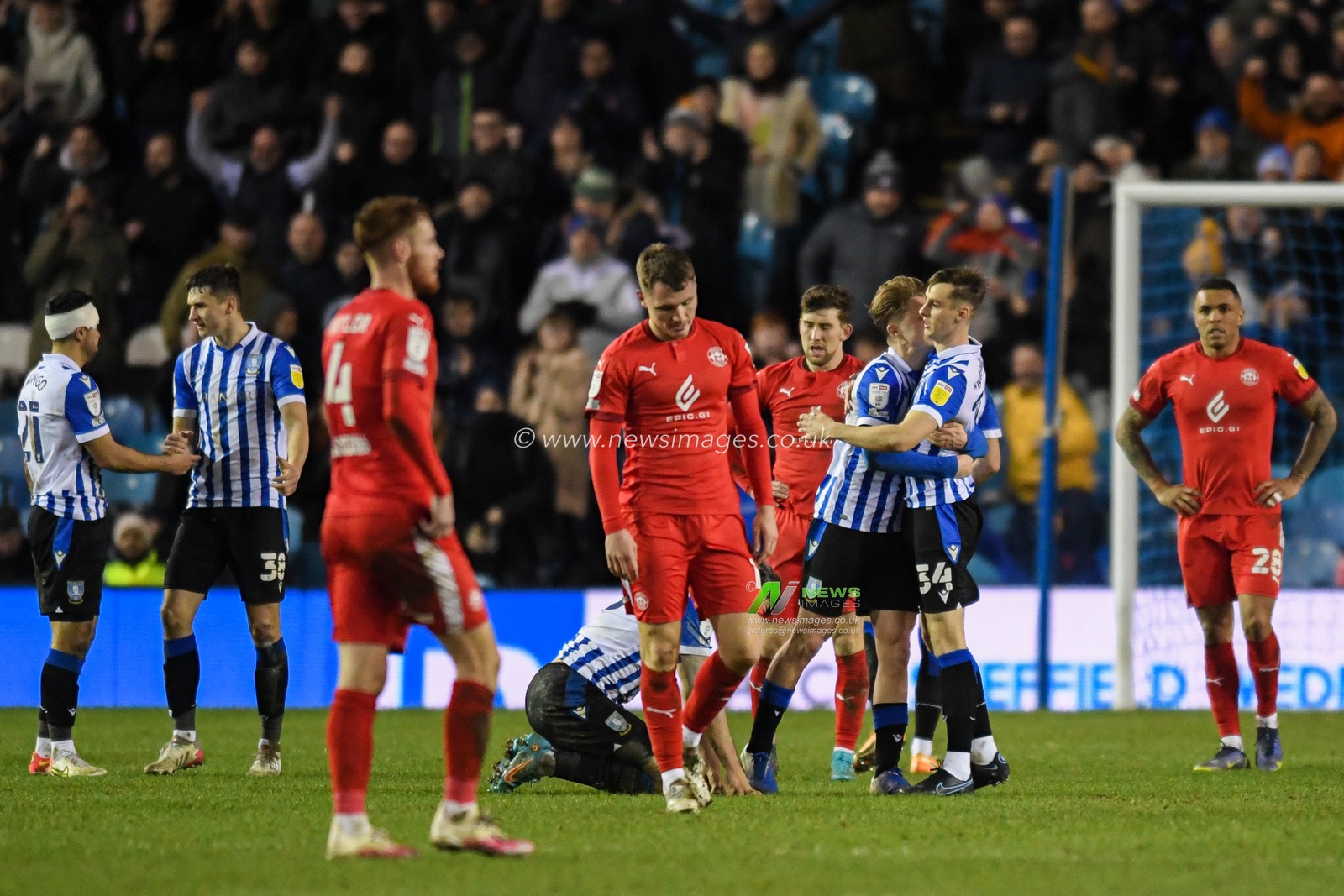 The Sheffield Wednesday players celebrate beating Wigan Athletic 1-0 at Hillsborough while the Wigan Athletic players look dejected
