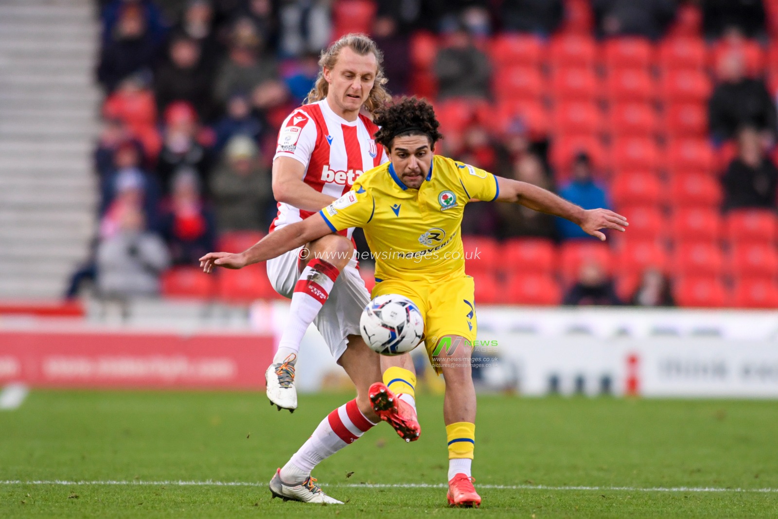 Reda Khadra #7 of Blackburn Rovers and Ben Wilmot #16 of Stoke City compete for the ball