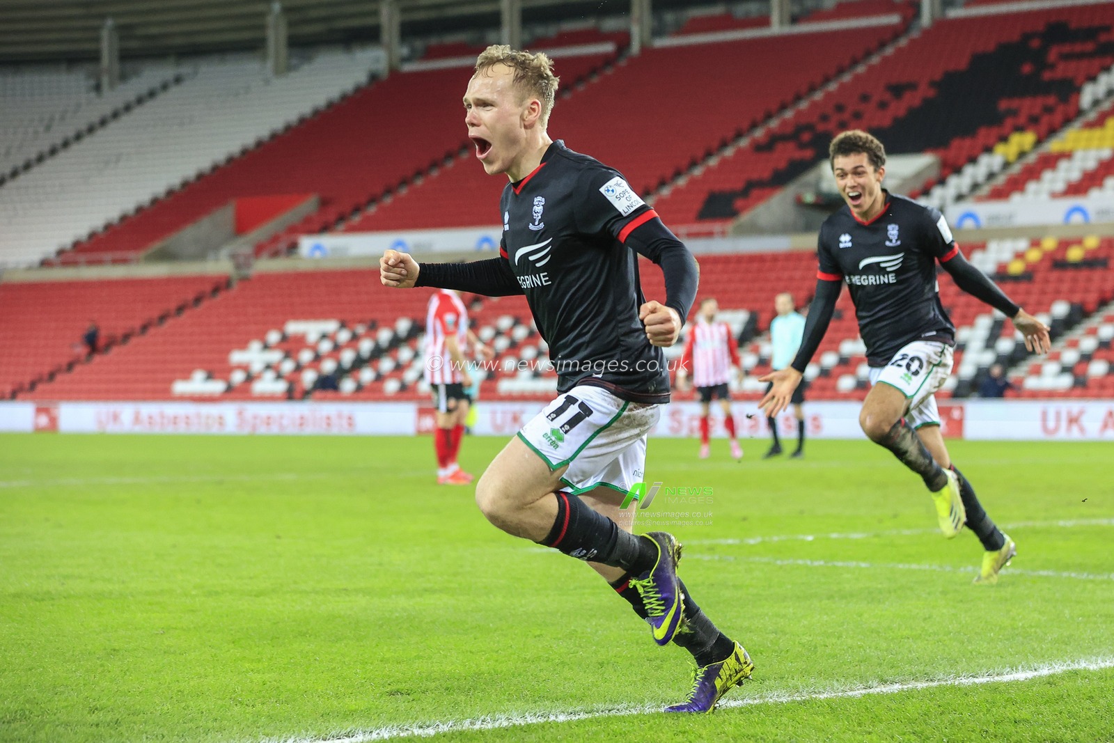Anthony Scully #11 of Lincoln City celebrates his goal to make it 0-1