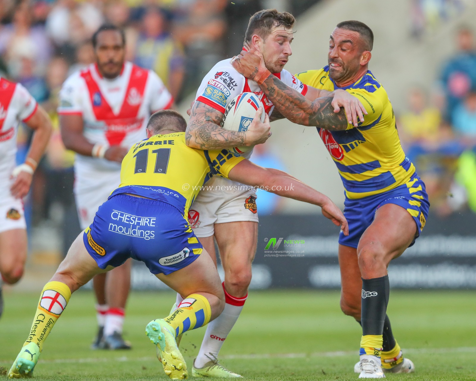 Ben Currie #11 of Warrington Wolves and Paul Vaughan #10 of Warrington Wolves tackle Mark Percival #4 of St Helens during the Betfred Super League Round 18 match Warrington Wolves vs St Helens at Halliwell Jones Stadium, Warrington, United Kingdom, 7th July 2023

(Photo by Gareth Evans/News Images)