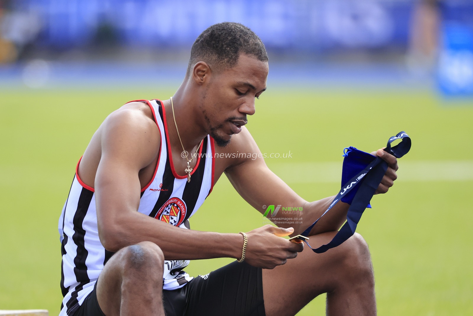 Zharnel Hughes looks at his gold medal after winning the menâ€™s 200m final during the UK Athletics Championships at Manchester Regional Arena, Manchester, United Kingdom, 9th July 2023

(Photo by Conor Molloy/News Images)