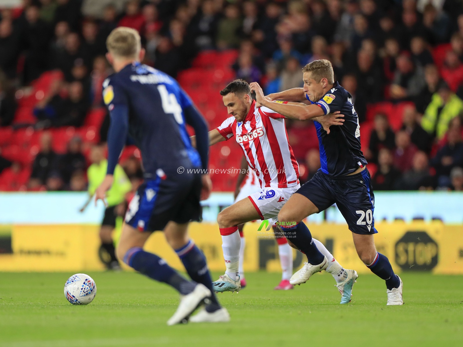 27th September 2019, Bet365 Stadium, Stoke-on-Trent, England; Sky Bet Championship, Stoke City v Nottingham Forest : Lee Gregory (19) of Stoke City is challenged by Michael Dawson (20) of Nottingham Forest

Credit: Conor Molloy/News Images