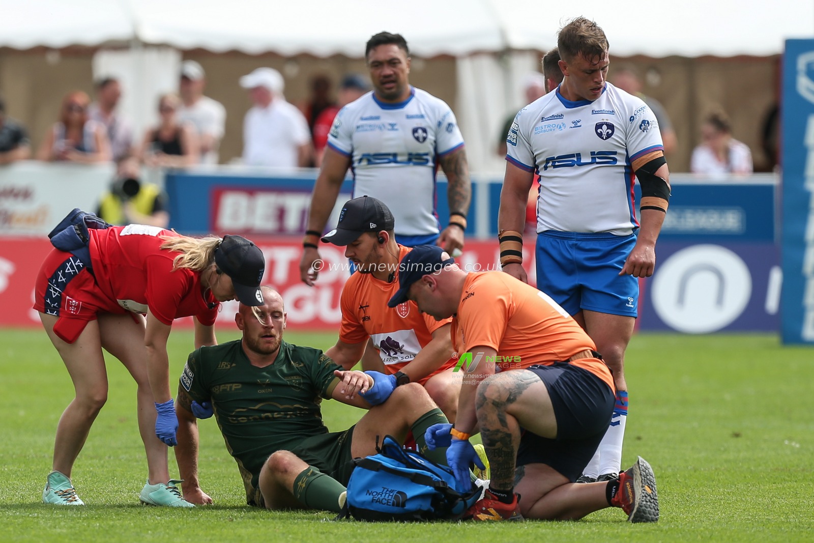 Dean Hadley #11 of Hull KR receives medical attention after being injured
