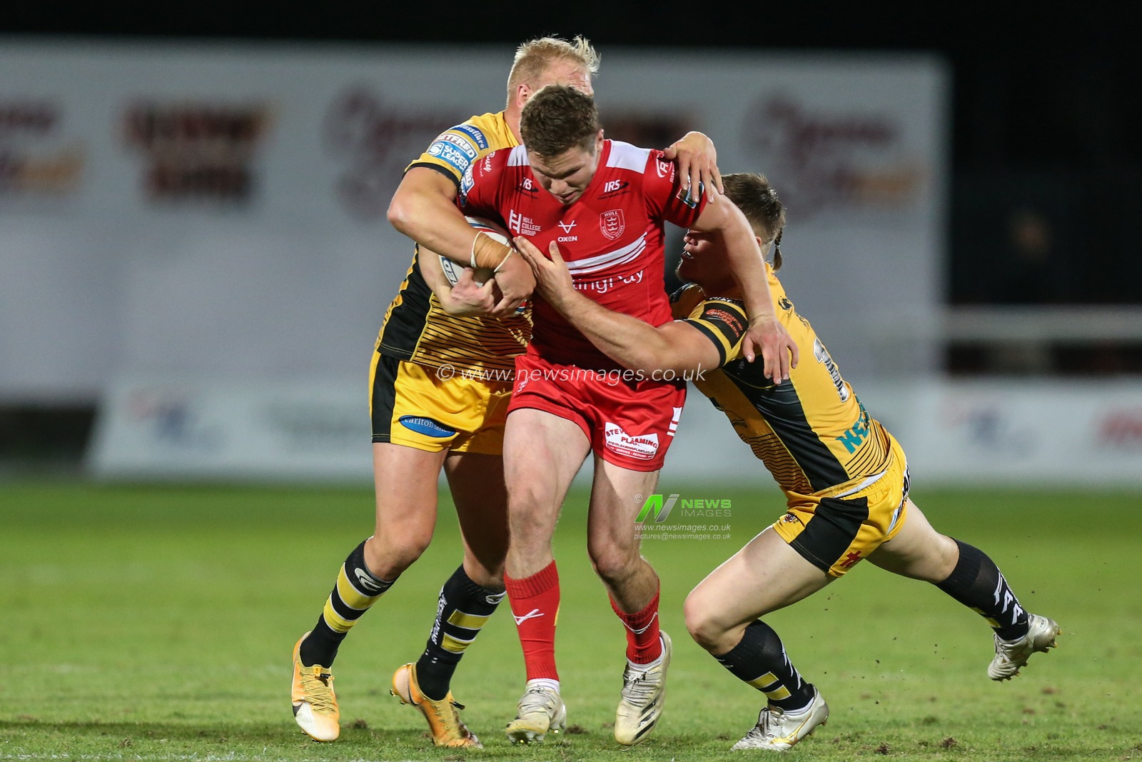 Matt Parcell (9) of Hull KR is tackled by Oliver Holmes (11) and Tyla Hepi (19) of Castleford Tigers