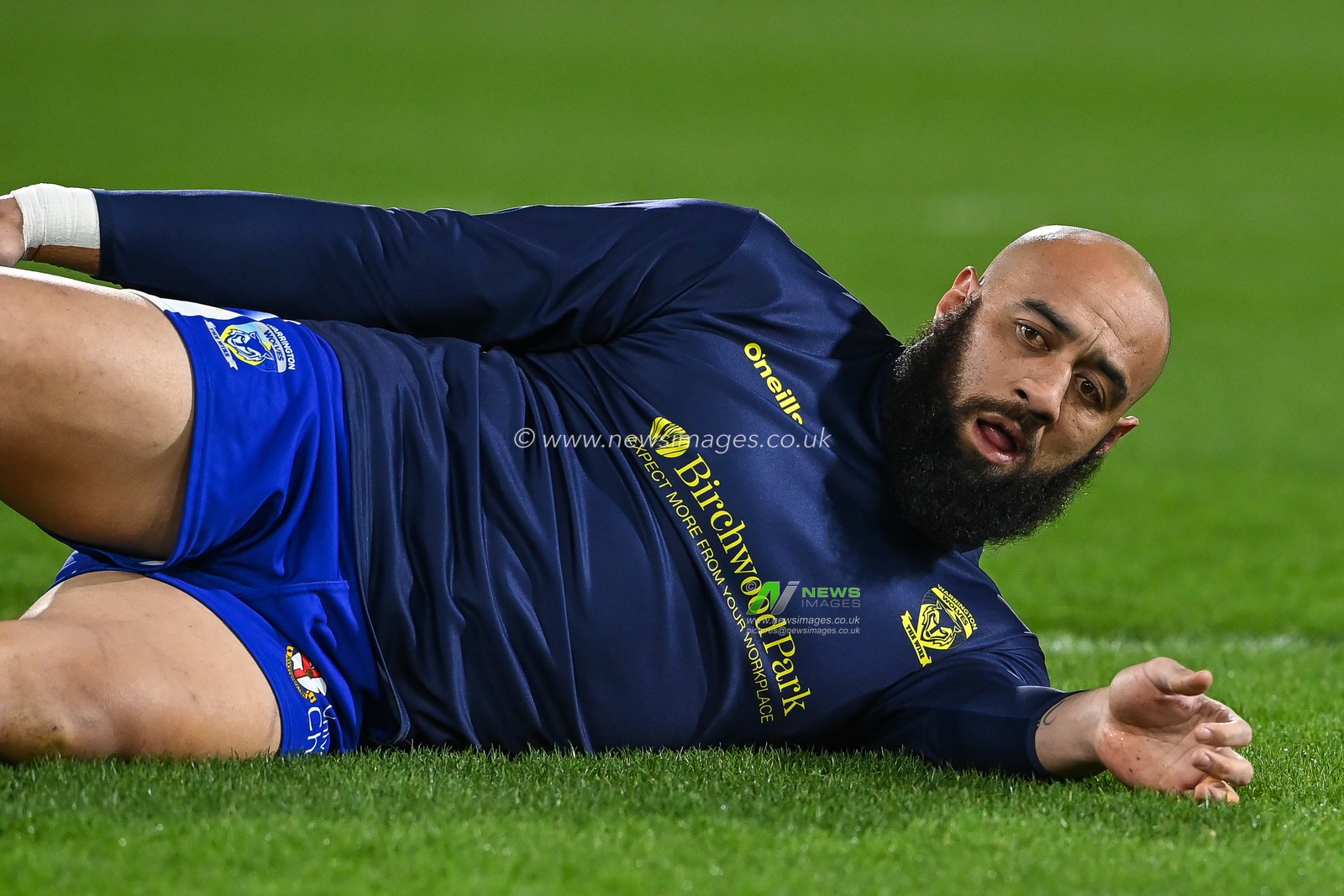 Sam Kasiano #14 of Warrington Wolves stretches during pre match warm up ahead of the Betfred Super League Round 2 match Huddersfield Giants vs Warrington Wolves at John Smith's Stadium, Huddersfield, United Kingdom, 24th February 2023

(Photo by Craig Thomas/News Images)