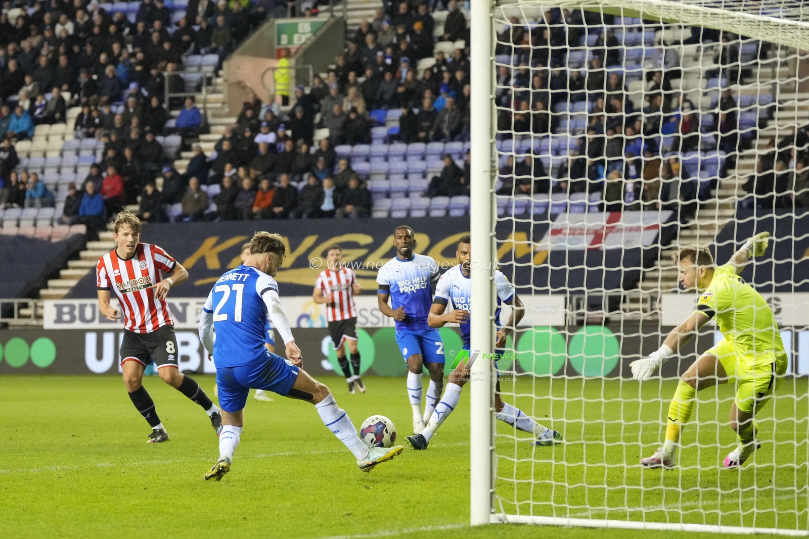 Joe Bennett #21 of Wigan Athletic clears a shot from Sander Berge #8 of Sheffield United during the Sky Bet Championship match Wigan Athletic vs Sheffield United at DW Stadium, Wigan, United Kingdom, 19th December 2022

(Photo by Steve Flynn/News Images)