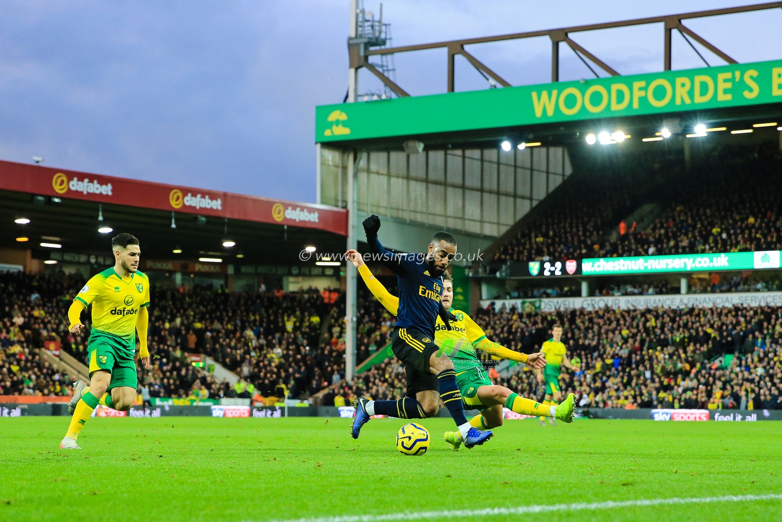 1st December 2019, Carrow Road, Norwich, England; Premier League, Norwich City v Arsenal : Alexandre Lacazette (09) of Arsenal is tackled by Tom Trybull (19) of Norwich City

Credit: Georgie Kerr/News Images