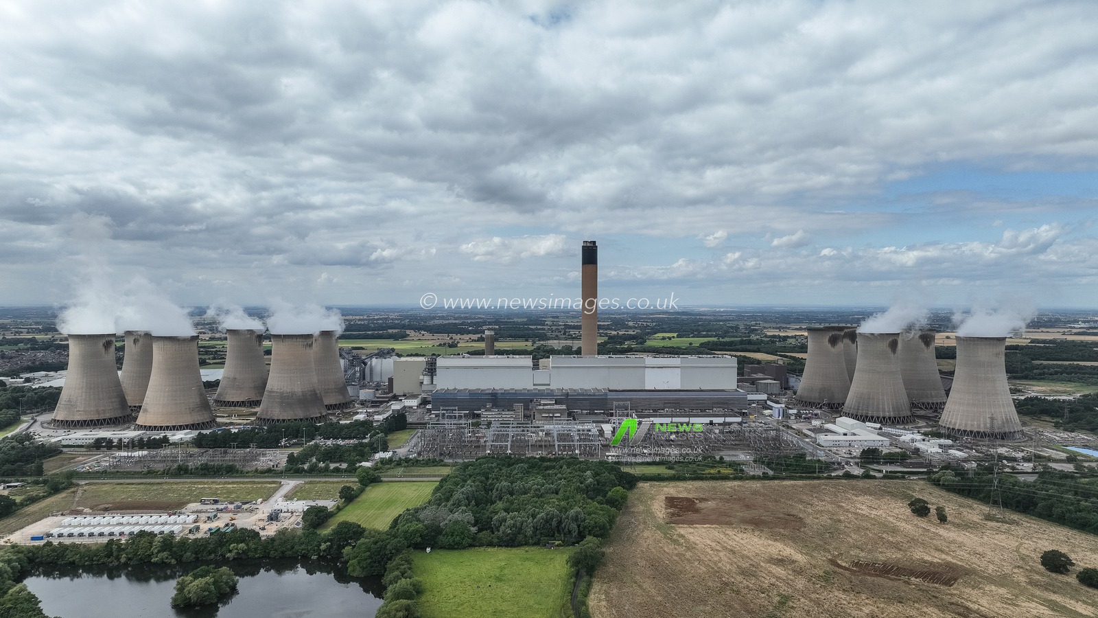 An aerial view of Drax Power Station. Drax Power Station is responsible for generating 11% of the renewable energy in the UK. It offers a secure, dependable, and adaptable source of renewable energy, which helps to complement more variable sources such as wind and solar power. Located near Selby in North Yorkshire, Drax is the largest single renewable energy site in the country, producing approximately 14 terawatt-hours (TWh) of electricityâ€”enough to supply power to around five million homes. 

By utilising biomass pellets, Drax significantly lowers its carbon emissions by 80% when compared to traditional coal. The facility comprises four biomass-fired units, each with a capacity of 645MW, contributing to its total output of about 14 terawatt-hours (TWh) at Drax Power Station, Selby, United Kingdom, 16th August 2024

(Photo by Mark Cosgrove/News Images)