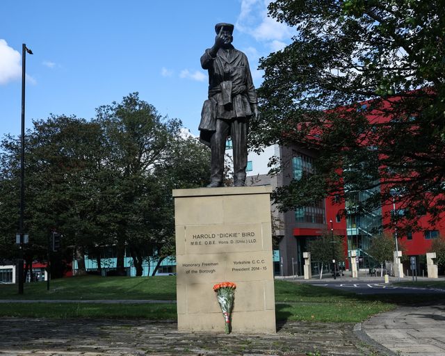 Flowers are laid at The Harold 'Dickie' Bird MBE, OBE statue after his passing today at the age of 92, Barnsley, United Kingdom, 23rd September 2025

(Photo by Mark Cosgrove/News Images)