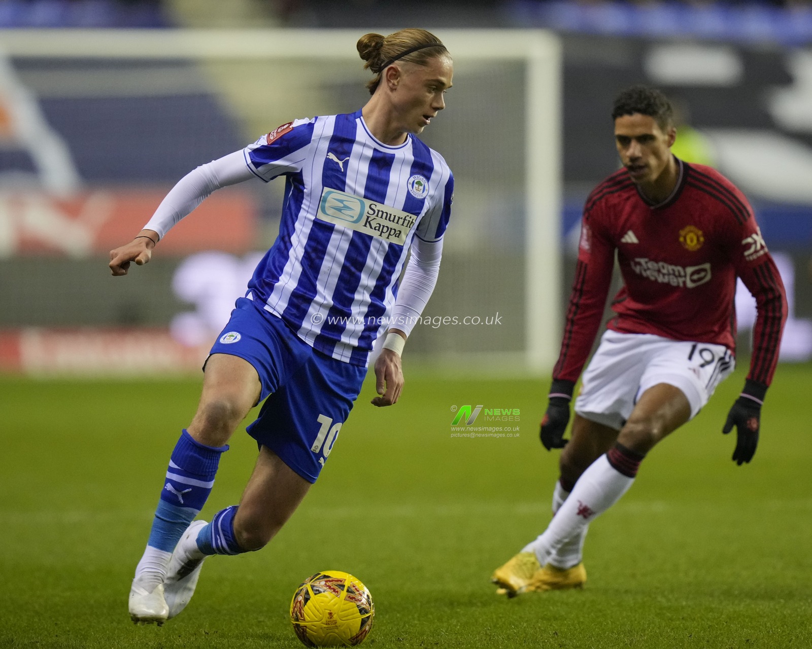 Thelo Aasgaard of Wigan Athletic breaks past RaphaÃ«l Varane of Manchester United during the Emirates FA Cup Third Round match Wigan Athletic vs Manchester United at DW Stadium, Wigan, United Kingdom, 8th January 2024

(Photo by Steve Flynn/News Images)