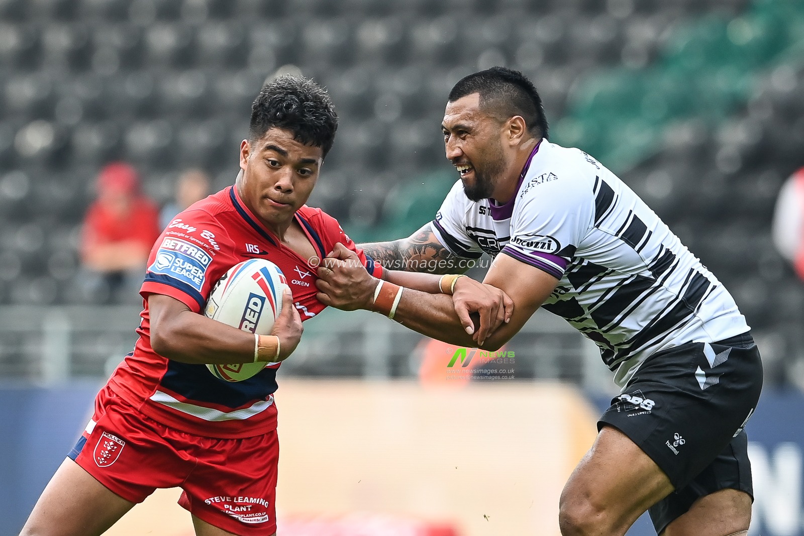Phoenix Laulu-Togagaâ€™e #29 of Hull KR is tackled by of Ligi Sao #8 of Hull FC makes a break during the Betfred Super League match Hull FC vs Hull KR at MKM Stadium, Hull, United Kingdom, 3rd September 2022

(Photo by Craig Thomas/News Images)