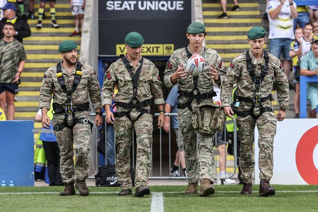 The British Marines deliver the match ball during the Betfred Super League round 15 match Warrington Wolves vs Huddersfield Giants at Halliwell Jones Stadium, Warrington, United Kingdom, 21st June 2025

(Photo by Alfie Cosgrove/News Images)