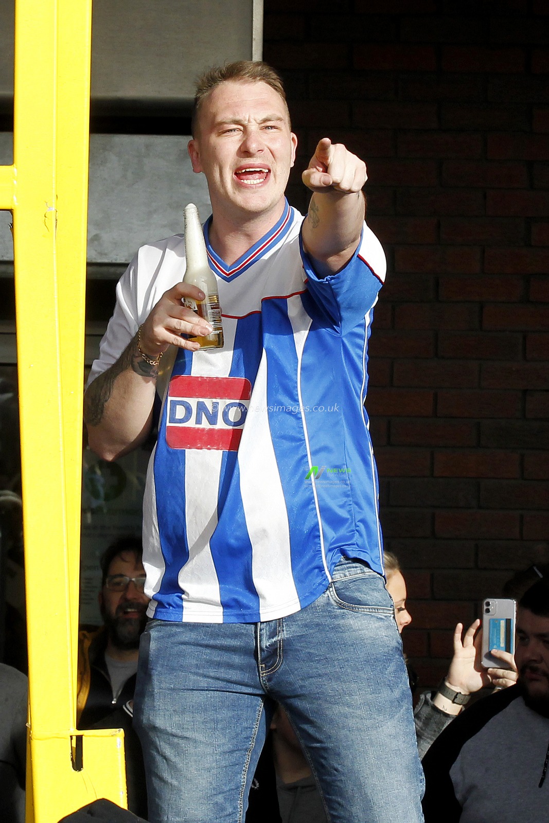 A Hartlepool United fan sings along with the cheerleaders