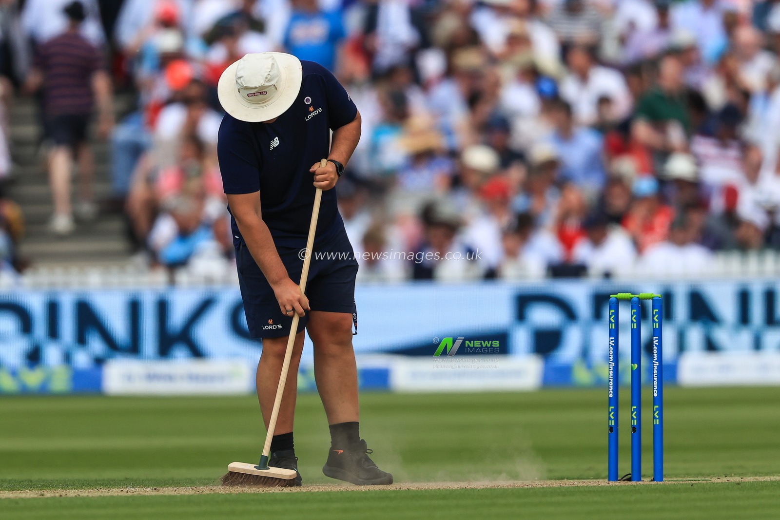 Ground staff brush the wicket