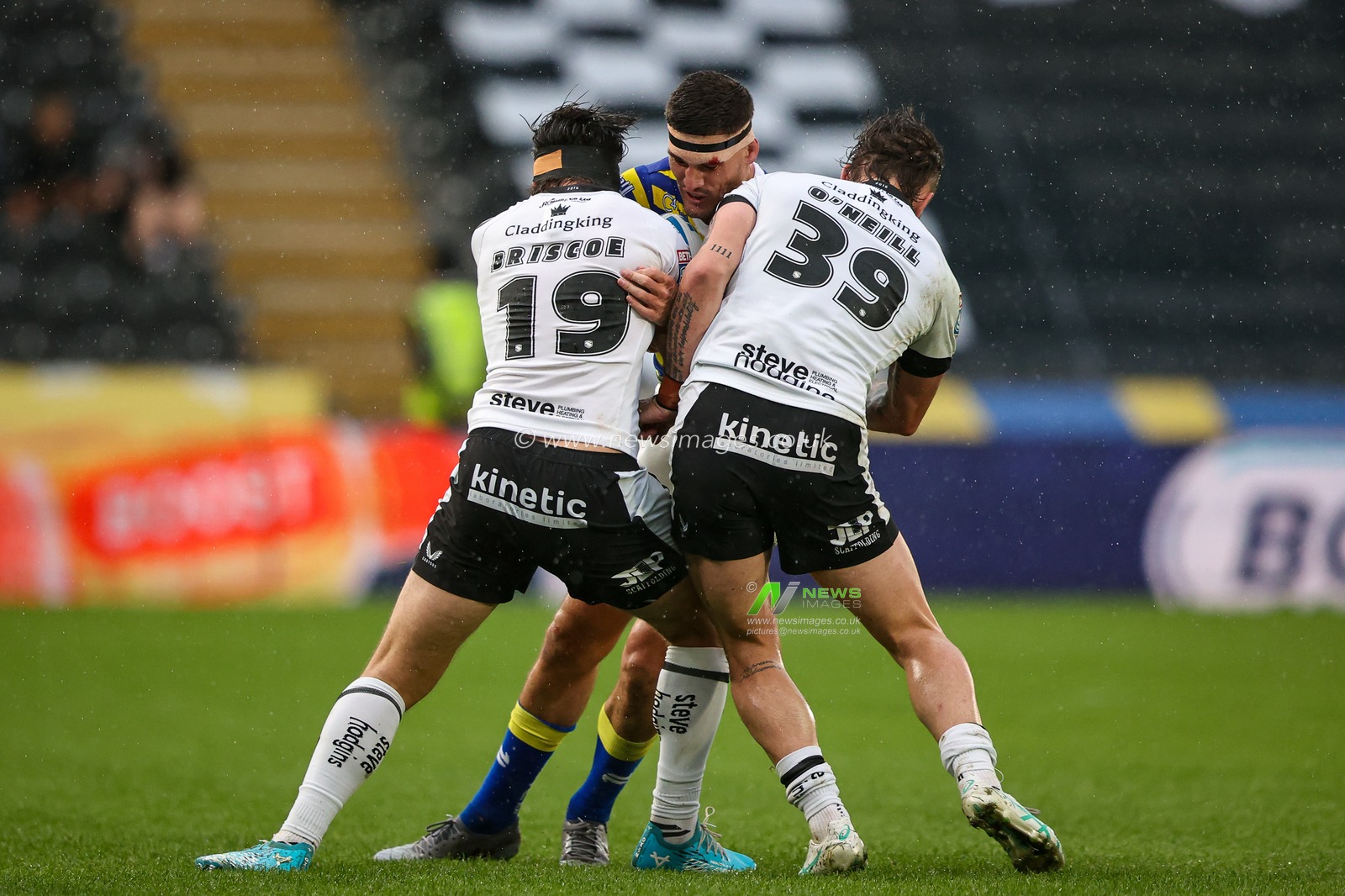 Sam Stone of Warrington Wolves is tackled by Tom Briscoe of Hull FC and Ethan O'Neill of Hull FC during the Betfred Super League round 25 match Hull FC vs Warrington Wolves at MKM Stadium, Hull, United Kingdom on 29 August 2026

(Photo by Alfie Cosgrove/News Images)