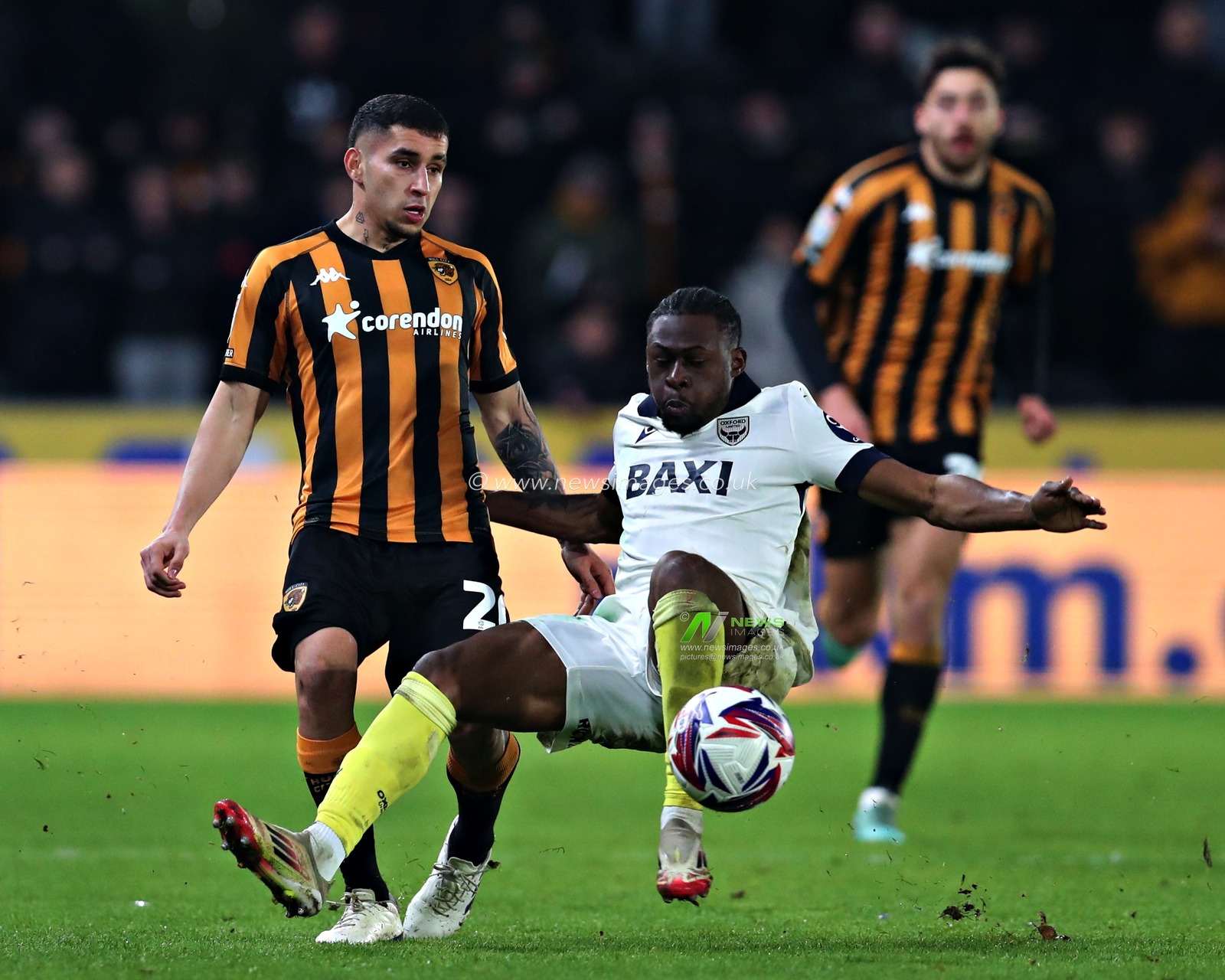 Alex Matos of Oxford United slides towards Gustavo Puerta of Hull City during the Sky Bet Championship match Hull City vs Oxford United at MKM Stadium, Hull, United Kingdom, 12th March 2025

(Photo by Sam Eaden/News Images)