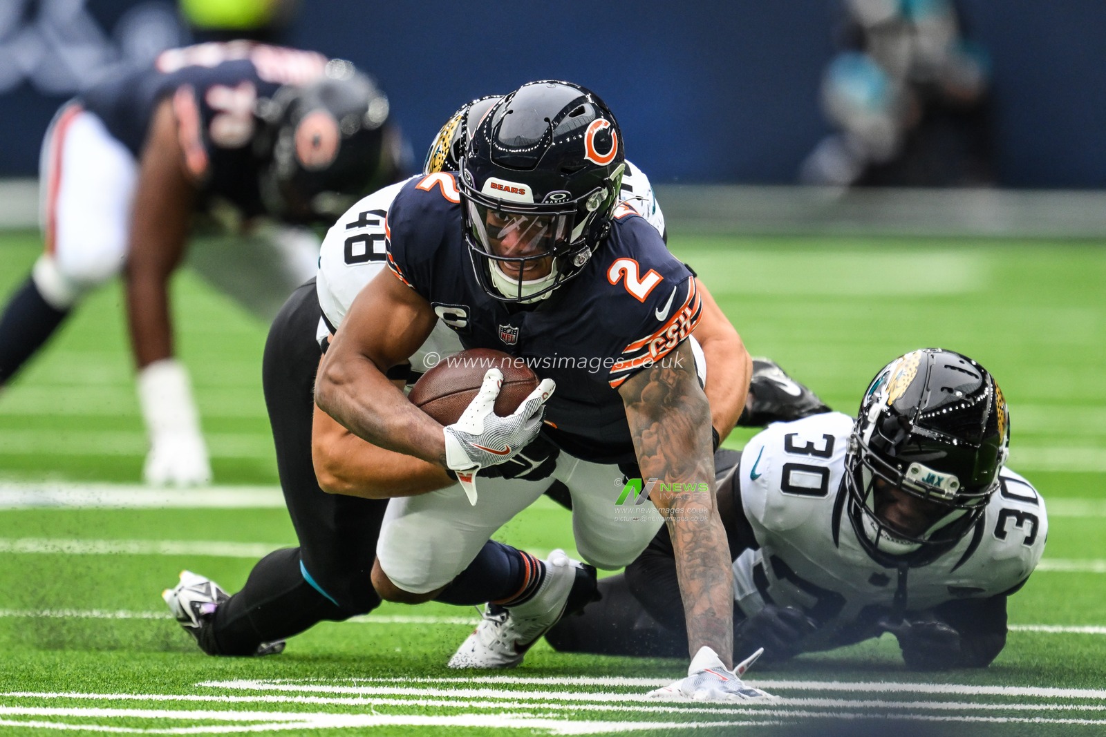 DJ Moore of the Chicago Bears is tackled by Montaric Brown of the Jacksonville Jaguars and Chad Muma of the Jacksonville Jaguars after making a catch during the Week 6 match Chicago Bears vs Jacksonville Jaguars at Tottenham Hotspur Stadium, London, United Kingdom, 13th October 2024

(Photo by Craig Thomas/News Images)