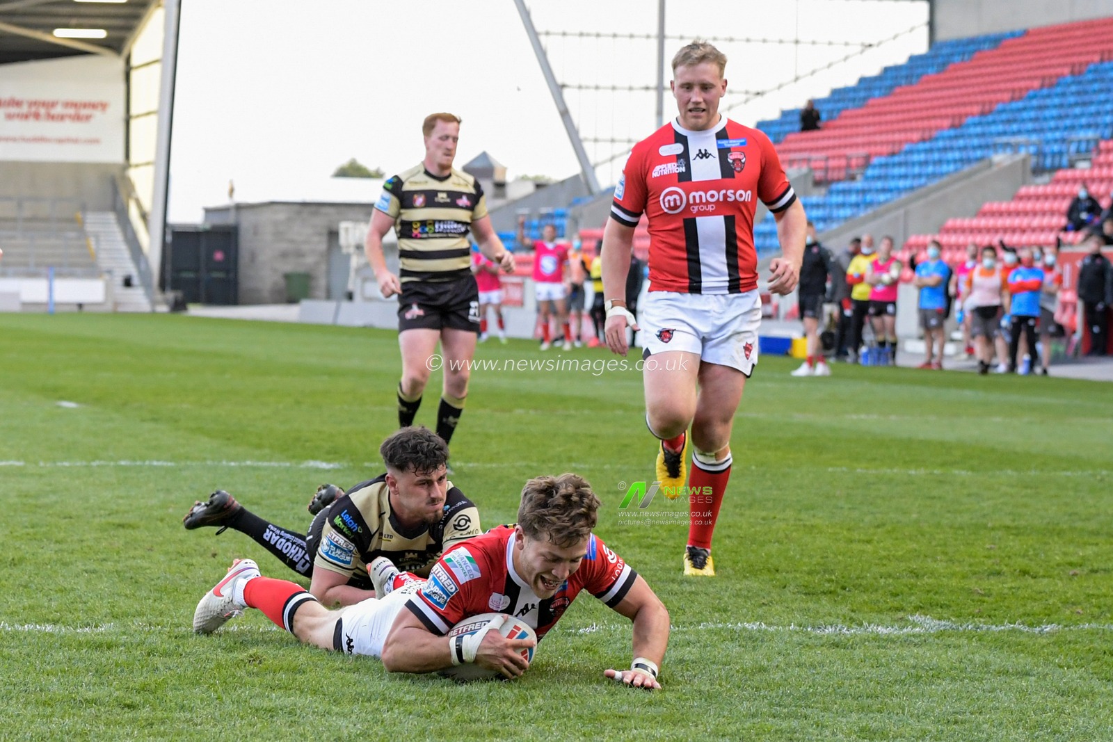 Chris Atkin (18) of Salford Red Devils goes over for a try to make it 26-8