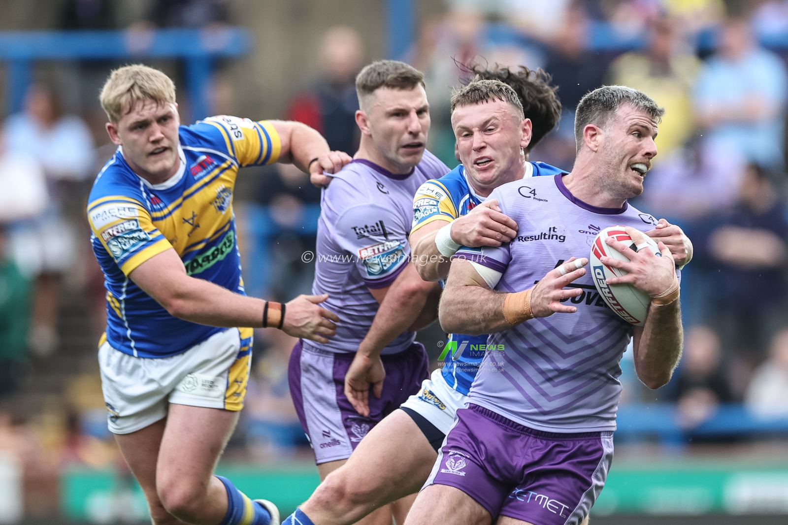 Lachlan Fitzgibbon of Warrington Wolves is tackled during the Betfred Super League Round 14 Leeds Rhinos v Warrington Wolves at Headingley Stadium, Leeds, United Kingdom, 14th June 2025

(Photo by Mark Cosgrove/News Images)
