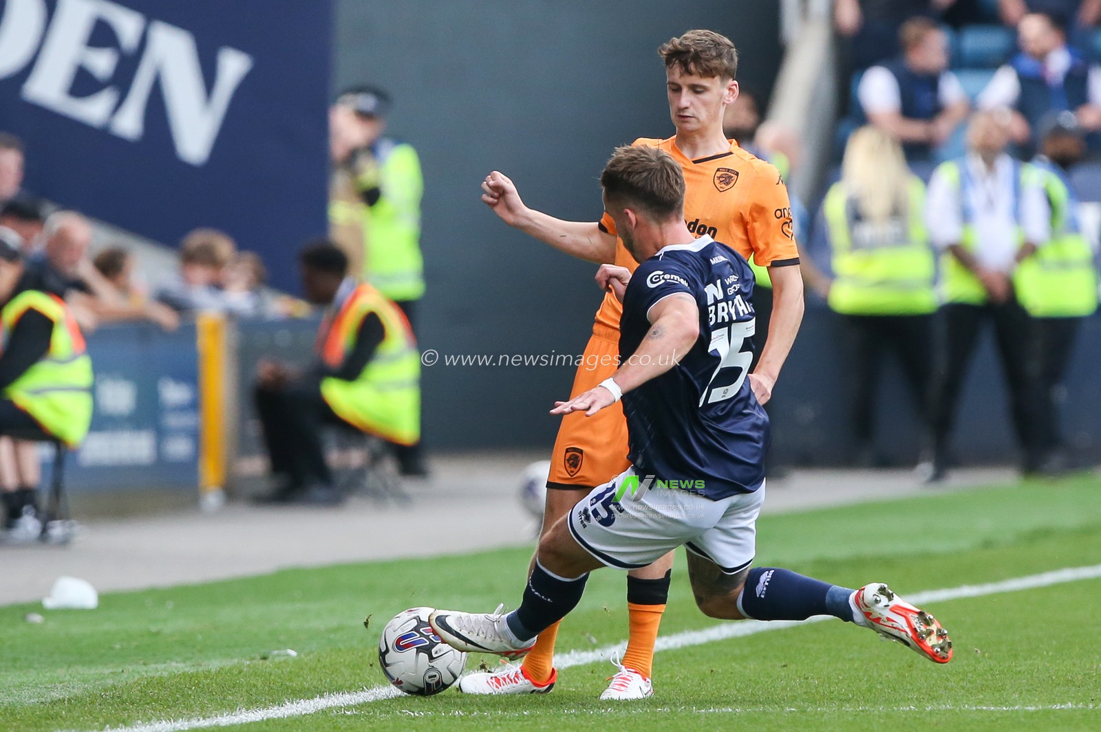 Tyler Morton #15 of Hull City  tackled by Joe Bryan #15 of Millwall during the Sky Bet Championship match Millwall vs Hull City at The Den, London, United Kingdom, 7th October 2023

(Photo by Arron Gent/News Images)
