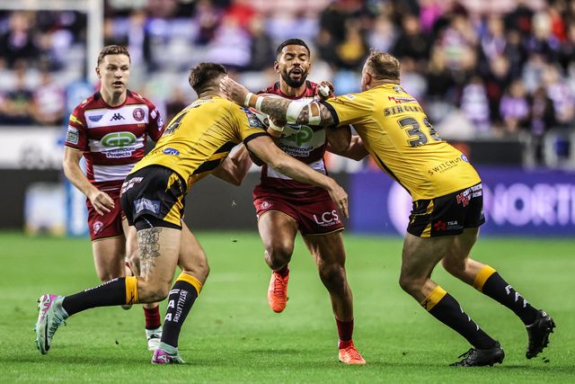 ﻿﻿Kruise Leeming of Wigan Warriors is tackled by Sam Wood of Castleford Tigers and Brad Singleton of Castleford Tigers during the Betfred Super League Round 26 match Wigan Warriors vs Castleford Tigers at The Brick Community Stadium, Wigan, United Kingdom, 12th September 2025

(Photo by Alfie Cosgrove/News Images)