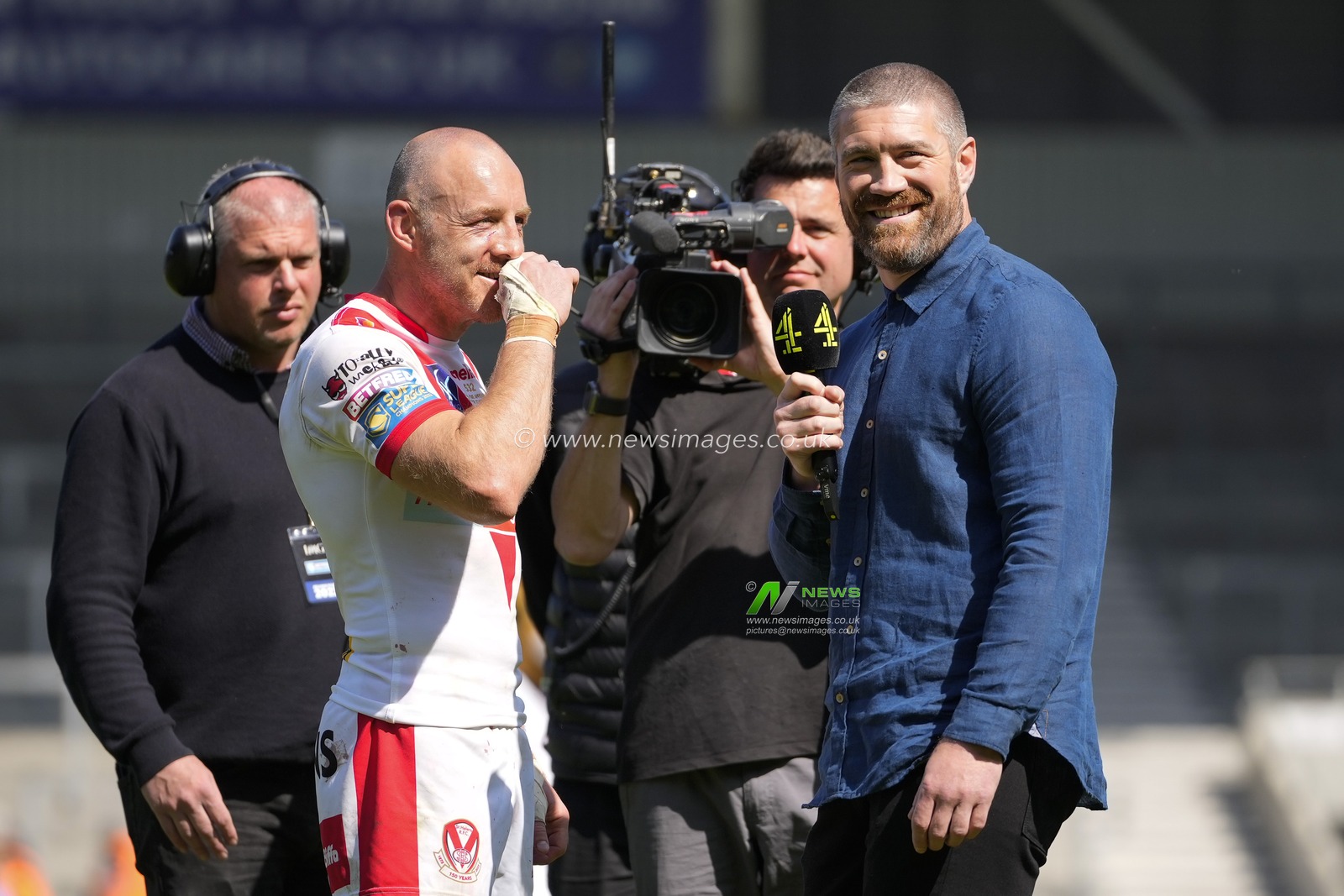 James Roby #9 of St. Helens and Channel 4 presenter Kyle Amor smile as the St Helens fan chant â€œone more yearâ€ as Toby is interviewed after the Betfred Super League Round 12 match St Helens vs Salford Red Devils at Totally Wicked Stadium, St Helens, United Kingdom, 13th May 2023

(Photo by Steve Flynn/News Images)