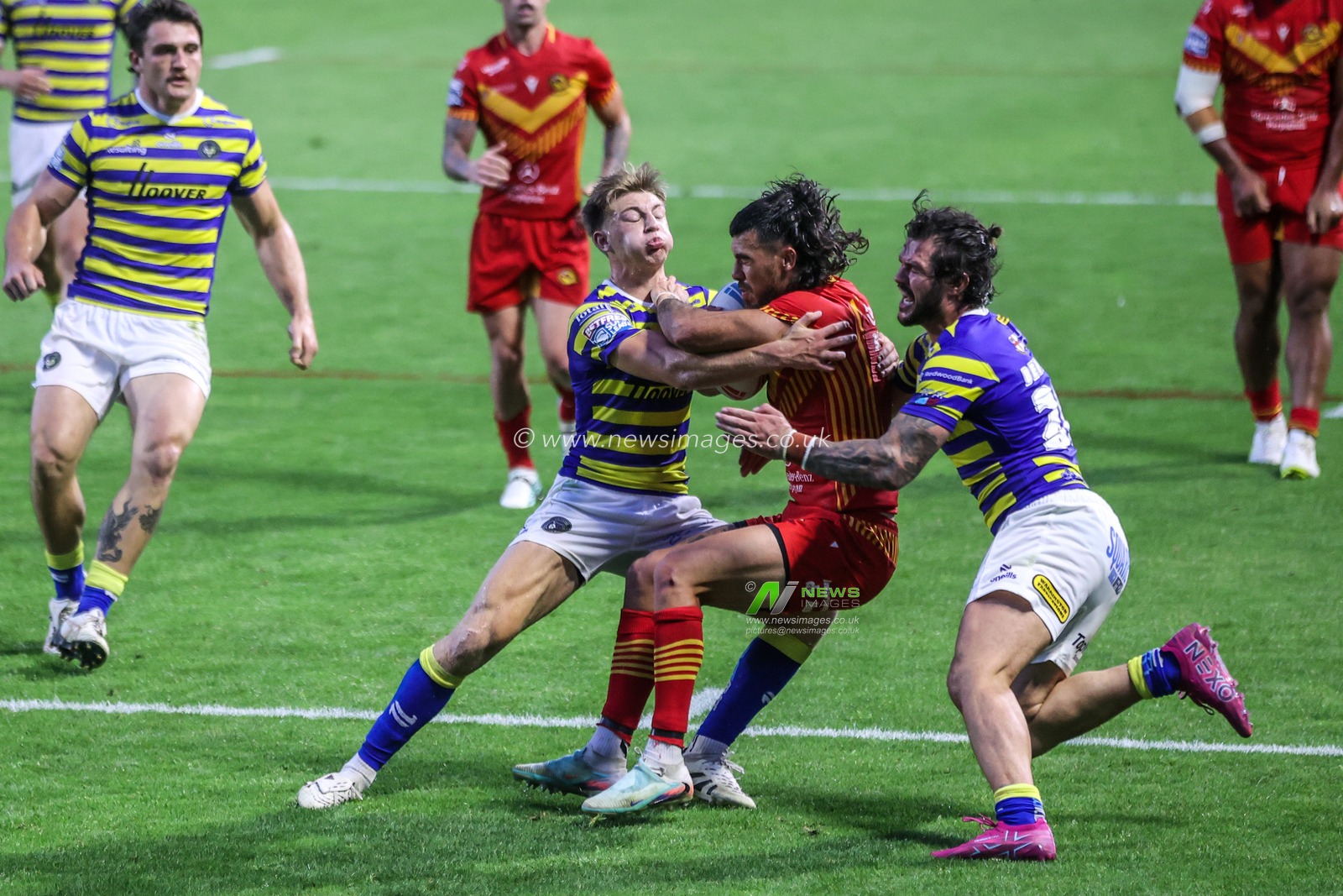 Charlie Staines of Catalans Dragons is tackled by Ewan Irwin of Warrington Wolves and James Bentley of Warrington Wolves during the Betfred Super League round 16 match Warrington Wolves vs Catalans Dragons at The Halliwell Jones Stadium, Warrington, United Kingdom on 25 June 2026

(Photo by Alfie Cosgrove/News Images)