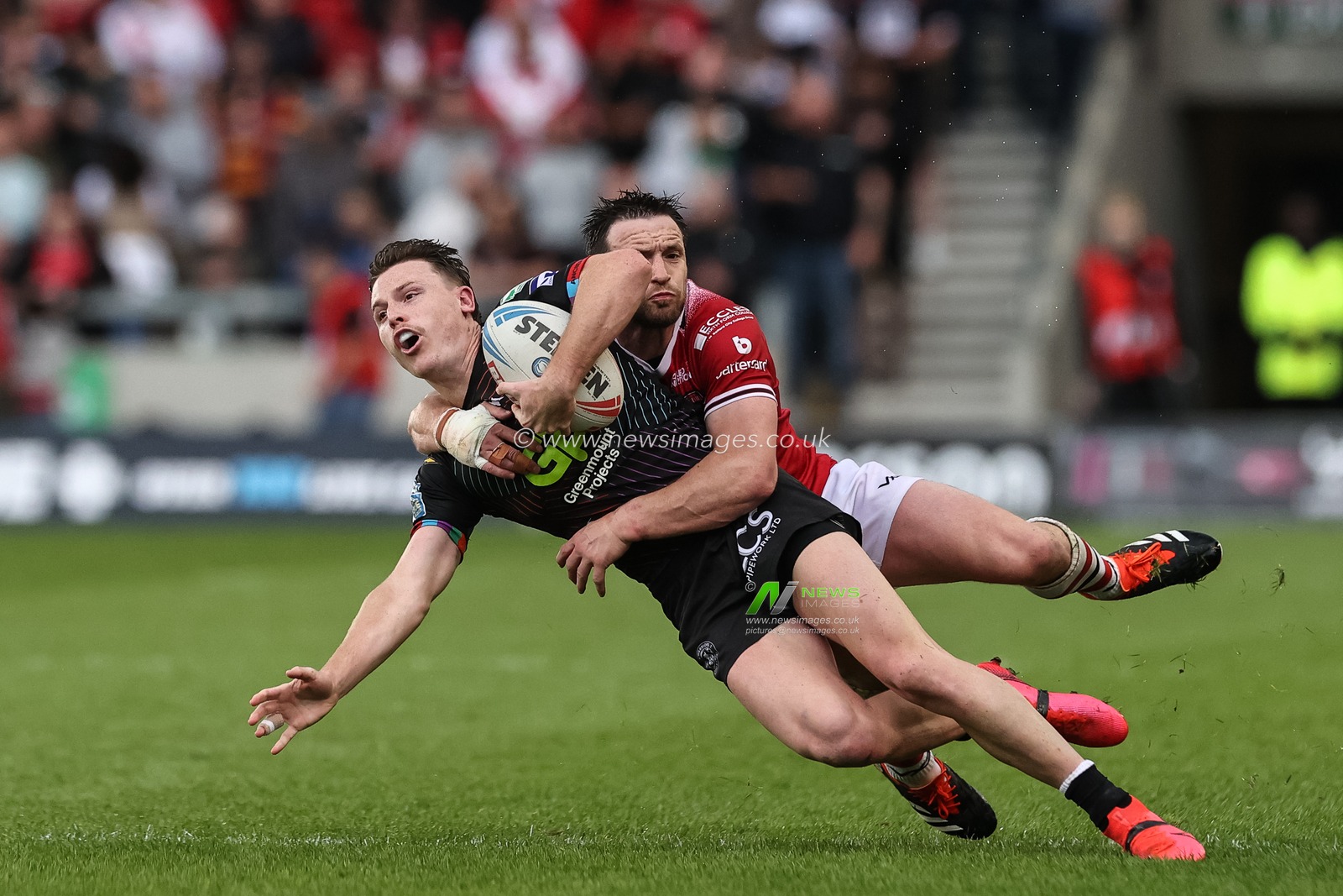Jai Field of Wigan Warriors is tackled by Joe Mellor of Salford Red Devils during the Betfred Super League Round 12 match Salford Red Devils vs Wigan Warriors at Salford Community Stadium, Eccles, United Kingdom, 26th May 2024

(Photo by Mark Cosgrove/News Images)