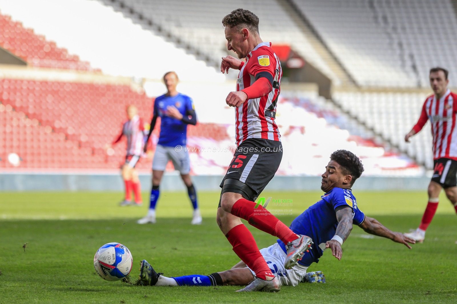 Ian Maatsen #22 of Charlton Athletic tackles Callum McFadzean #25 of Sunderland inside the Charlton Athletic penalty area