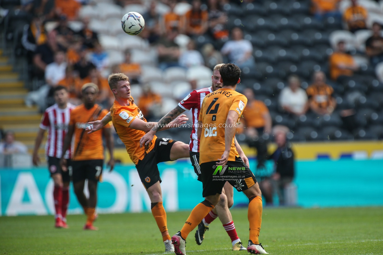 Andy Cannon #14 of Hull City challenges for the ball