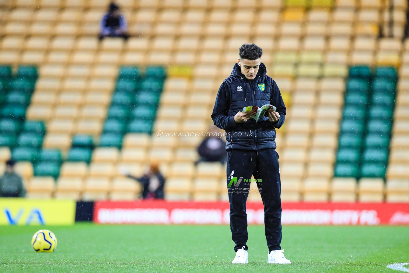 15th February 2020, Carrow Road, Norwich, England; Premier League, Norwich City v Liverpool : Max Aarons (02) of Norwich City reads the match day programme ahead of kick-off
