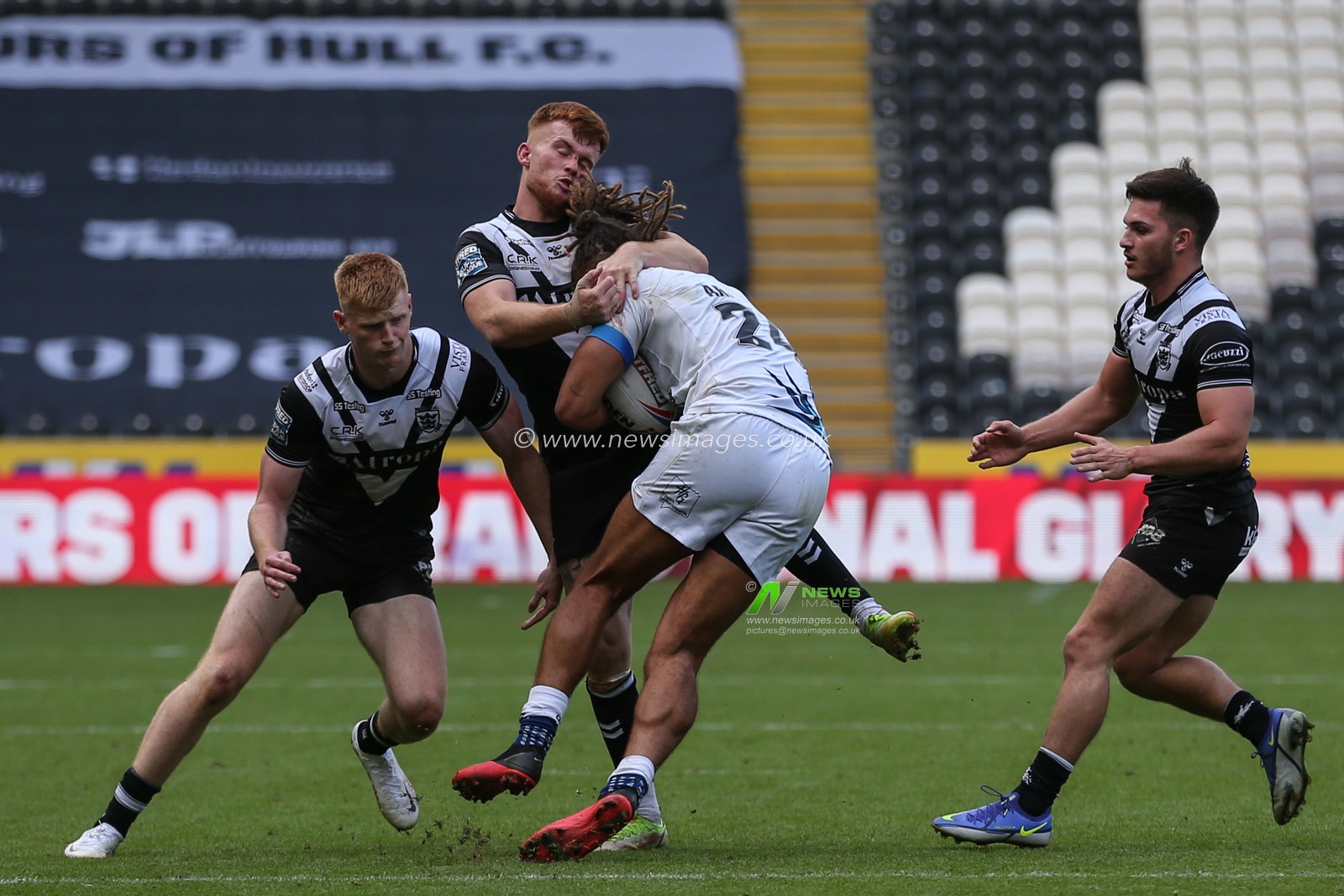 Ellis Longstaff #38 of Hull FC tackles Guy Armitage #24 of Toulouse Olympique
