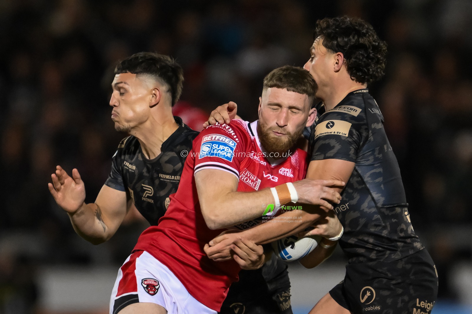 Ethan Ryan of Salford Red Devils is tackled by Lachlan Lam of Leigh Leopards and Owen Trout of Leigh Leopards during the Betfred Super League play-off Eliminator 1 Salford Red Devils v Leigh Leopards at Salford Community Stadium, Eccles, United Kingdom, 27th September 2024

(Photo by Craig Thomas/News Images)
