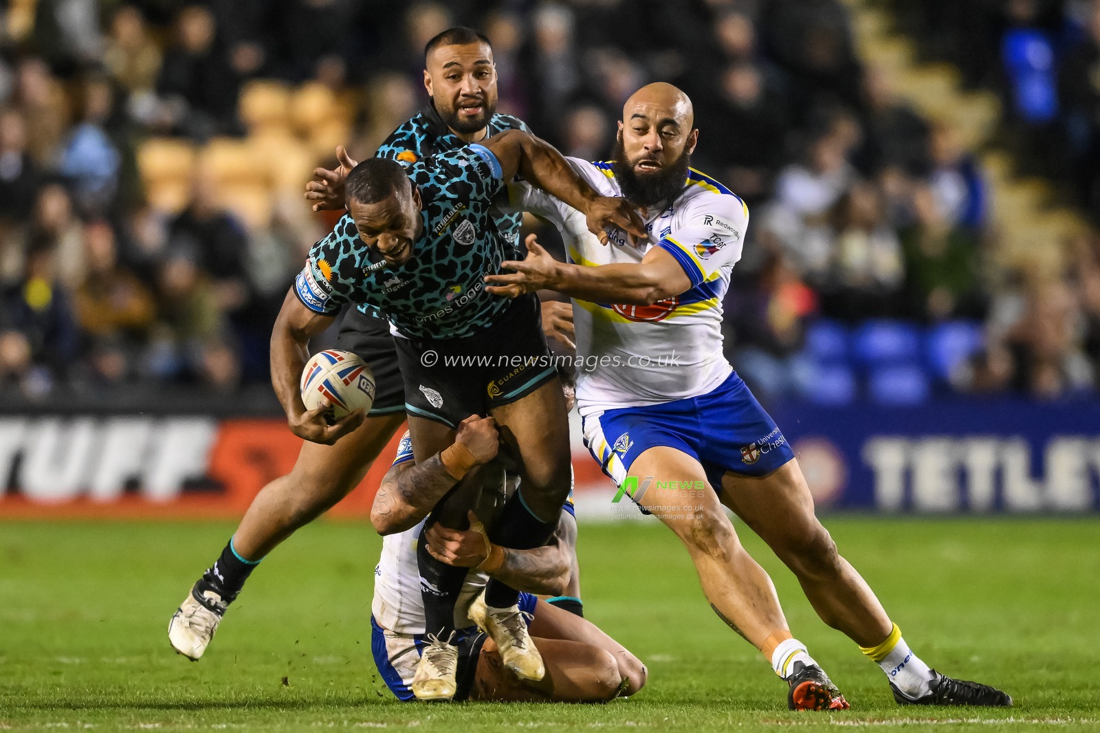 Edwin Ipape #9 of Leigh Leopards is tackled by Paul Vaughan #10 and Sam Kasiano #14 of Warrington Wolves  during the Betfred Super League Round 5 match Warrington Wolves vs Leigh Leopards at Halliwell Jones Stadium, Warrington, United Kingdom, 17th March 2023

(Photo by Craig Thomas/News Images)