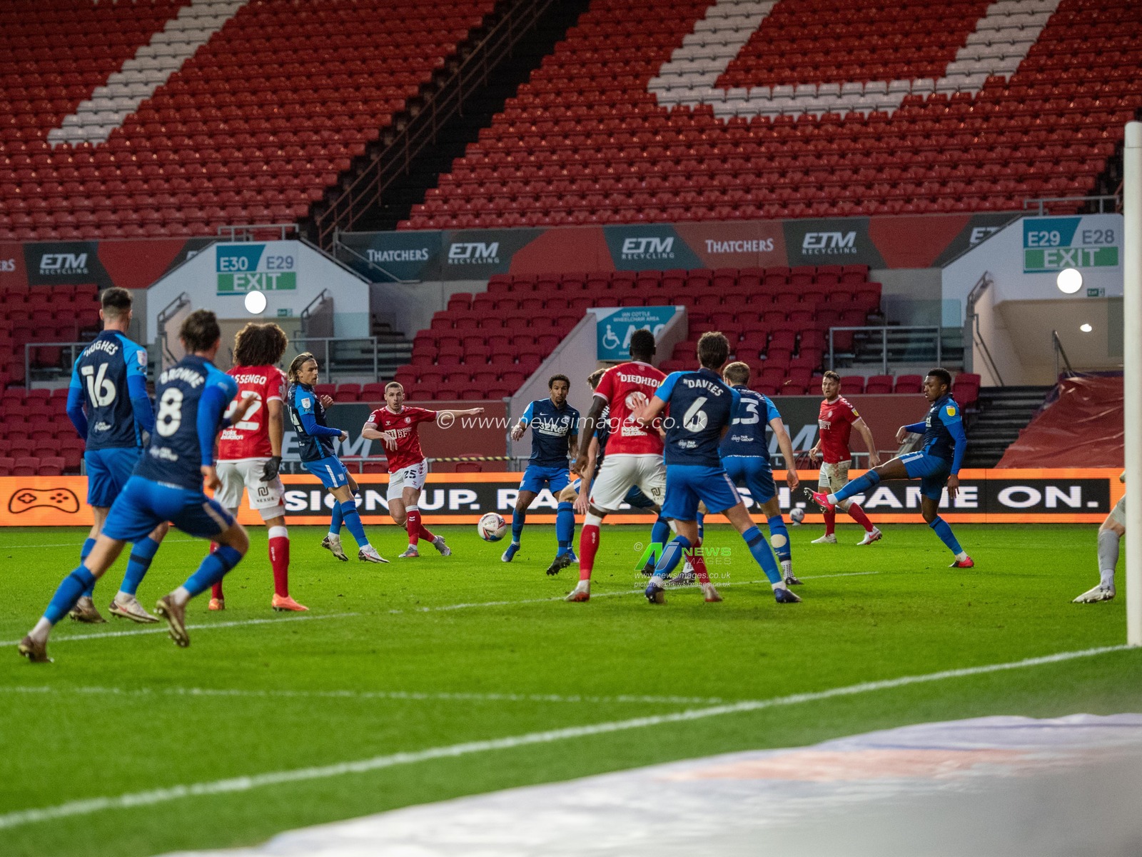 Tommy Rowe #25 of Bristol City shoots at goal between a sea of players
