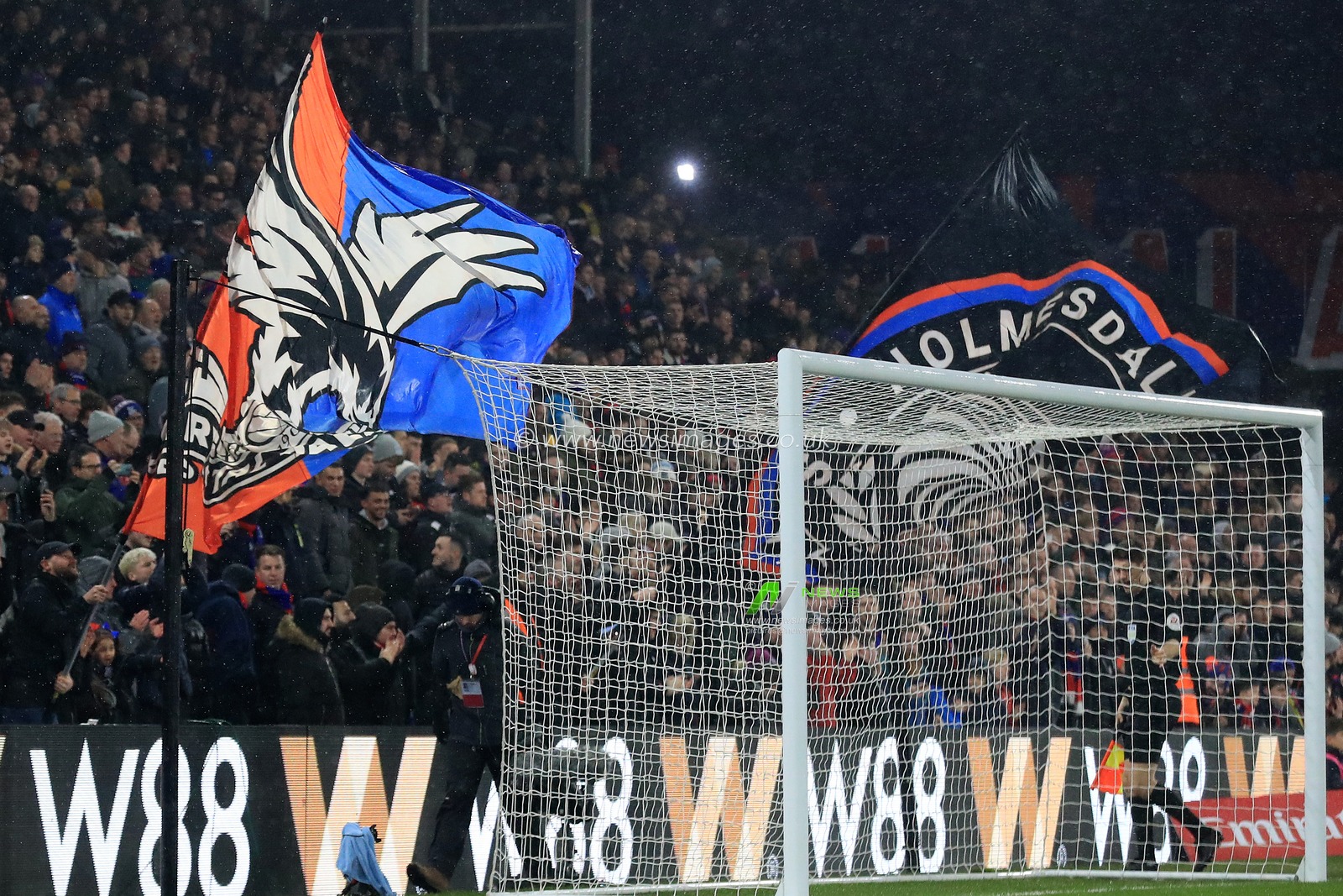 Crystal Palace fans wave flags and banners.