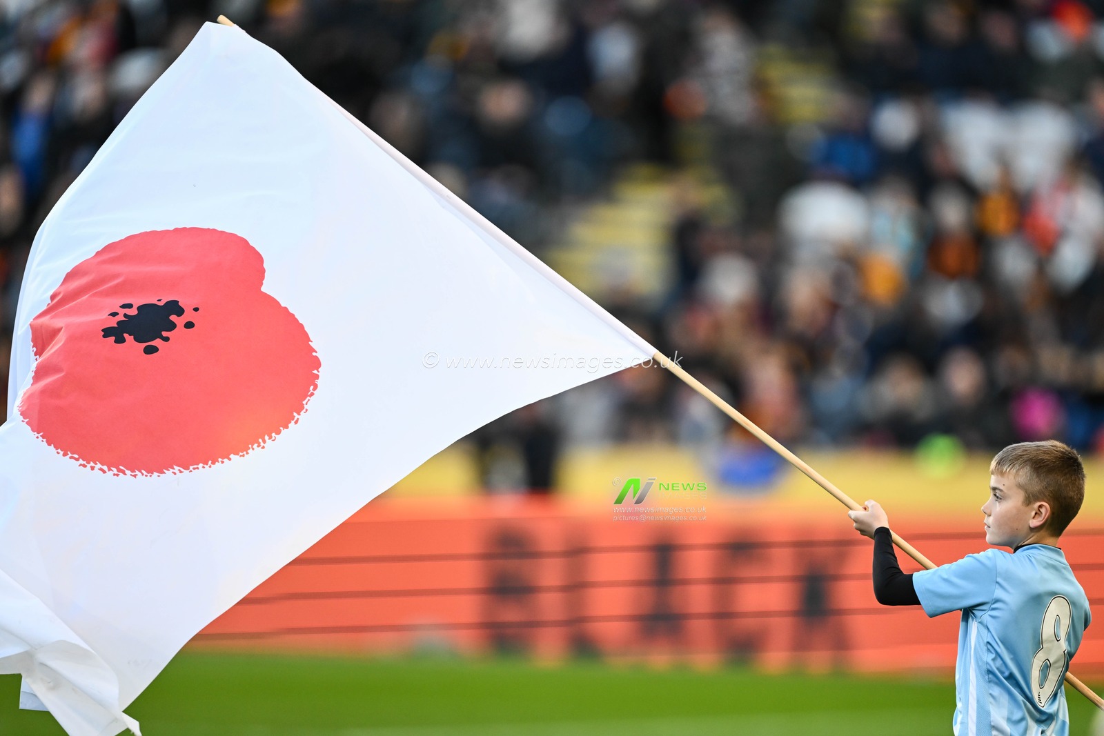 Young mascot waves a poppy flag ahead of the gameduring the Sky Bet Championship match Hull City vs Huddersfield Town at MKM Stadium, Hull, United Kingdom, 11th November 2023

(Photo by Craig Thomas/News Images)