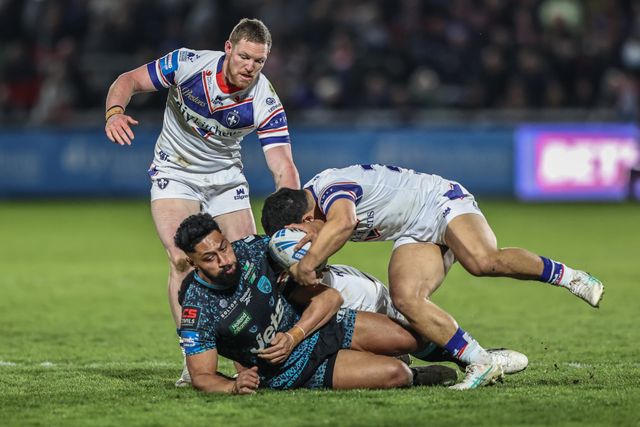 Isaac Liu of Leigh Leopards is tackled by Mason Lino of Wakefield Trinity, Ky Rodwell of Wakefield Trinity and Isaiah Vagana of Wakefield Trinity during the Betfred Challenge Cup Quarter Final match Wakefield Trinity vs Leigh Leopards at DIY Kitchens Stadium, Wakefield, United Kingdom, 4th April 2025

(Photo by Alfie Cosgrove/News Images)