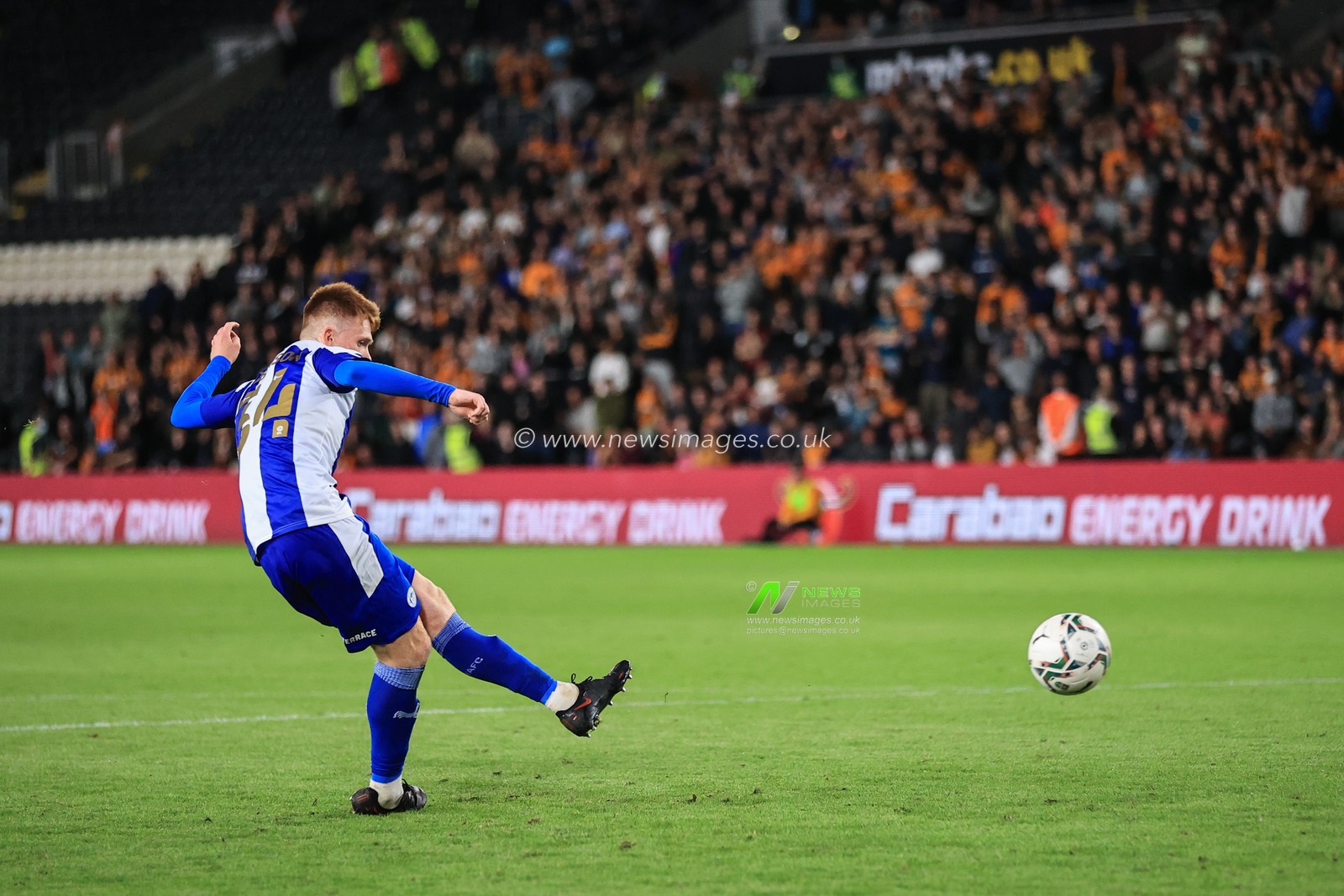Luke Robinson #34 of Wigan Athletic scores his penalty