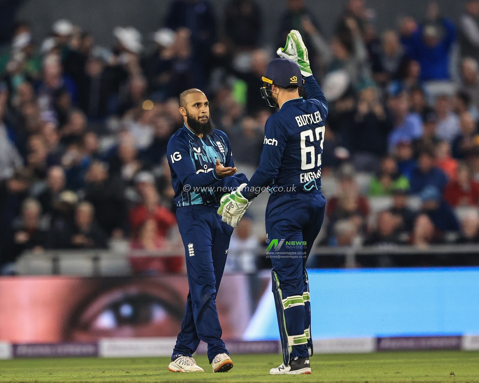 Adil Rashid of England celebrates catching Lungi Ngidi of South Africa with Jos Buttler of England