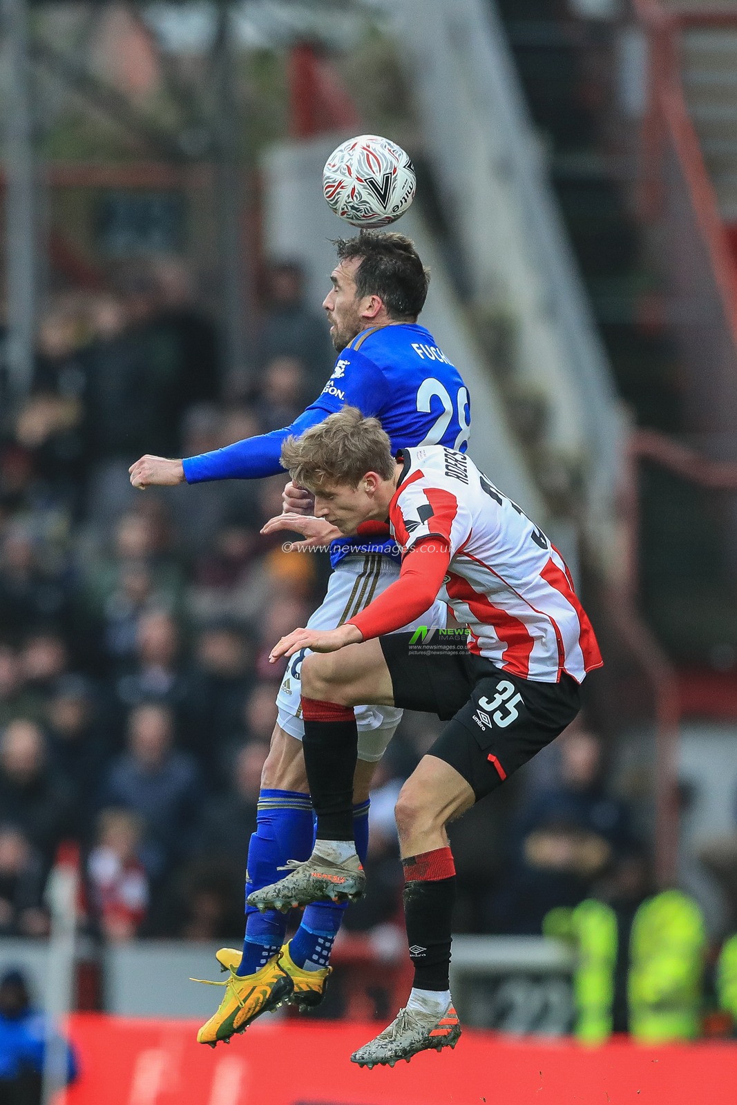 25th January 2020, Griffin Park, London, England; Emirates FA Cup, Brentford v Leicester City : Christian Fuchs (28) of Leicester City header and Mads Roersley of Brentford