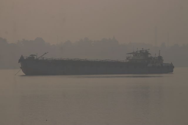 A cargo ship is parked the Ganga River on a dense, foggy morning amid rising air pollution levels in Kolkata, India, on January 4,2025.Pictures by Debajyoti Chakraborty.(Photo: Debajyoti Chakraborty/News Images)
