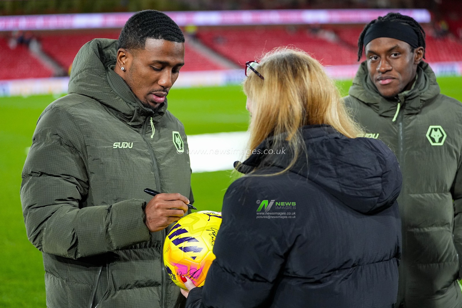 Jackson Tchatchoua of Wolverhampton Wanderers signs his autograph on a matchball during the Premier League match Nottingham Forest vs Wolverhampton Wanderers at City Ground, Nottingham, United Kingdom on 11 February 2026

(Photo by Maynard Manyowa/News Images)