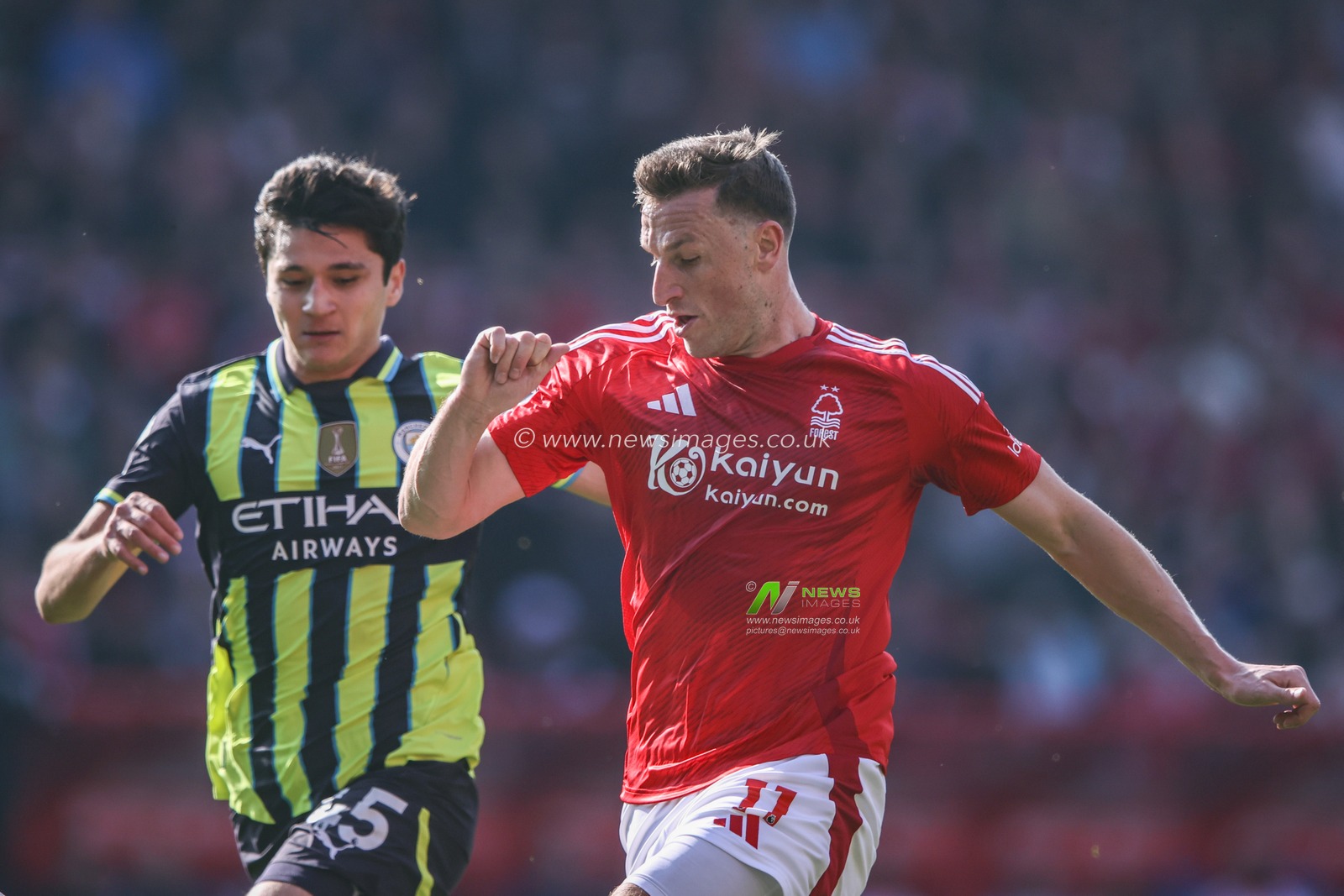 Abdukodir Khusanov of Manchester City and Chris Wood of Nottingham Forest battle for the ball during the Premier League match Nottingham Forest vs Manchester City at City Ground, Nottingham, United Kingdom, 8th March 2025

(Photo by Alfie Cosgrove/News Images)